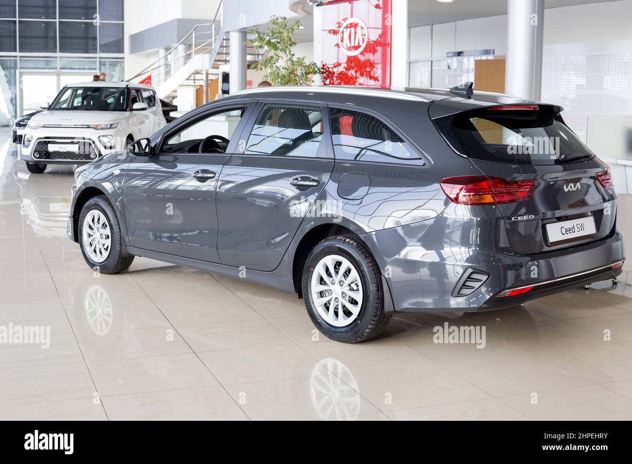 Russia, Izhevsk - February 17, 2022: KIA showroom. New modern Ceed SW estate car in dealer showroom. Back and side view. Famous world brand. Stock Photo