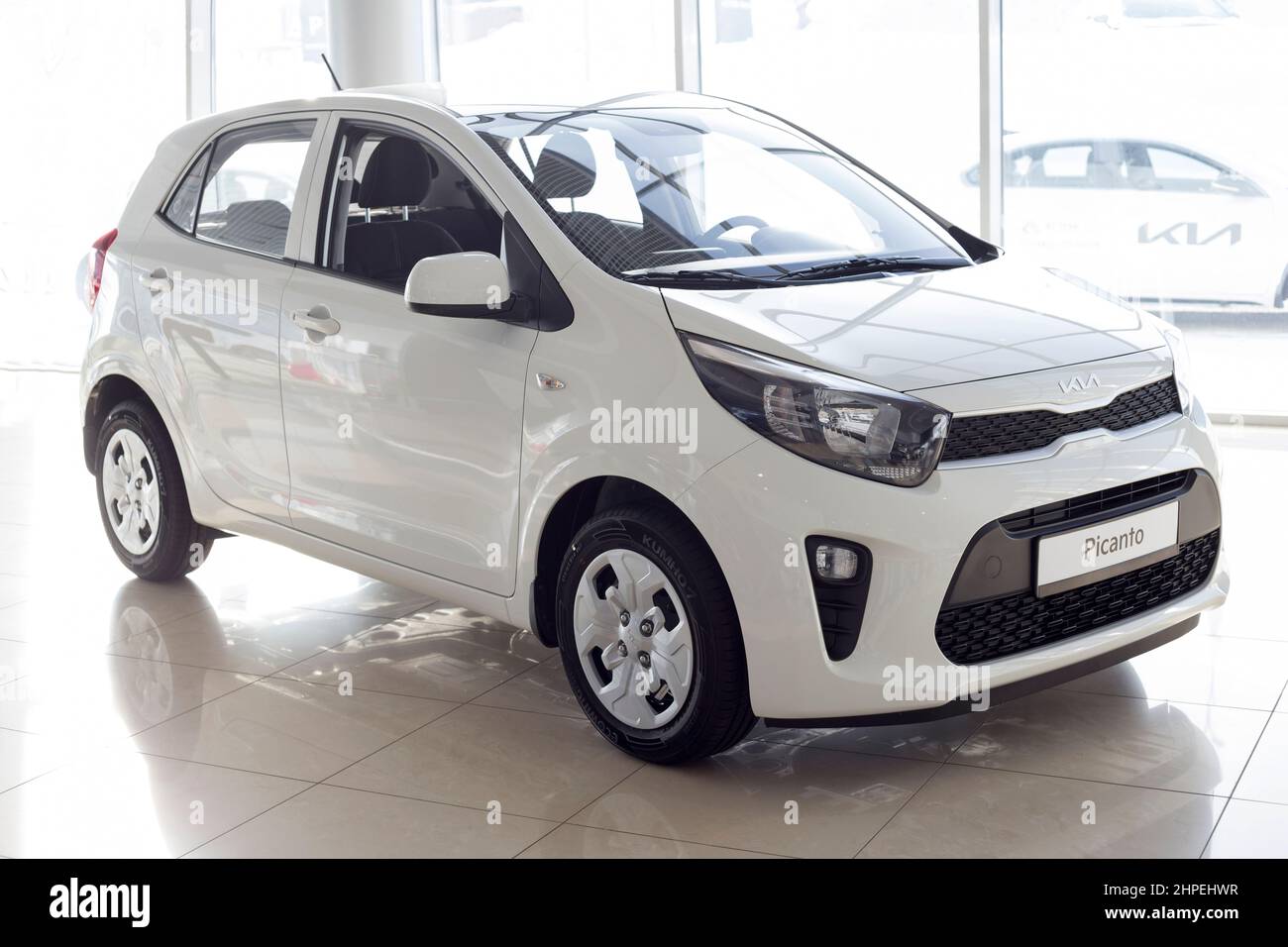 Russia, Izhevsk - February 17, 2022: KIA showroom. New modern KIA Picanto in dealer showroom. Front and side view. Famous world brand. Stock Photo