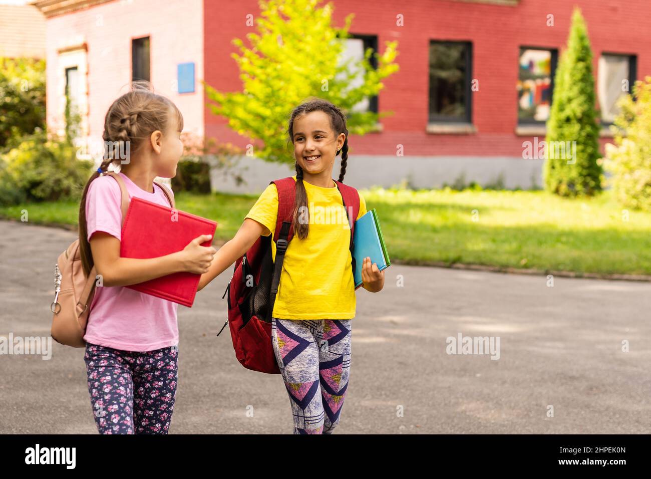 Two happy school girls in the park Stock Photo - Alamy