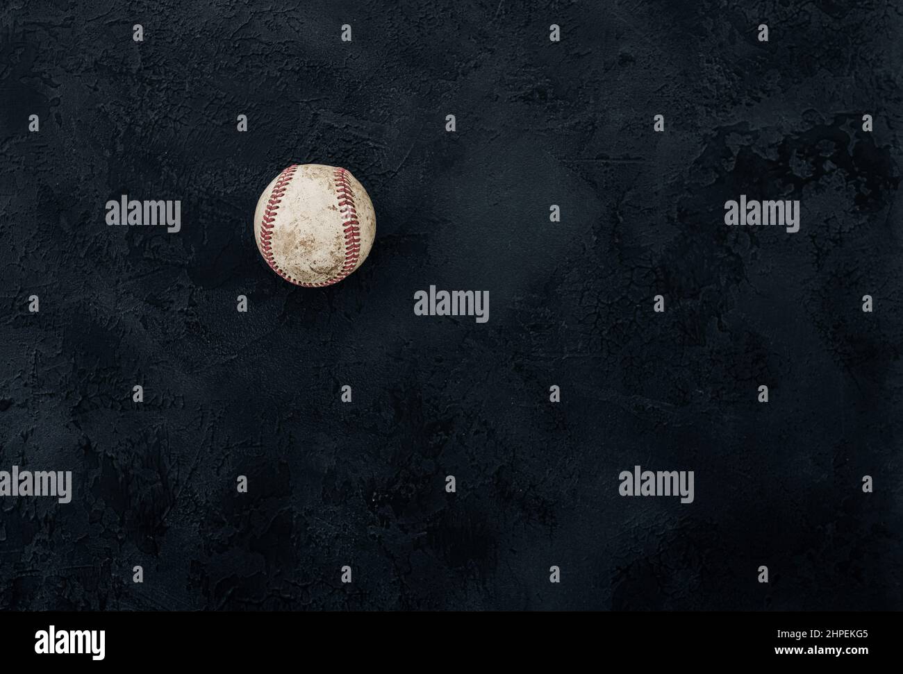 Baseball ball on a black background. old used ball on a dark texture. space for text Stock Photo