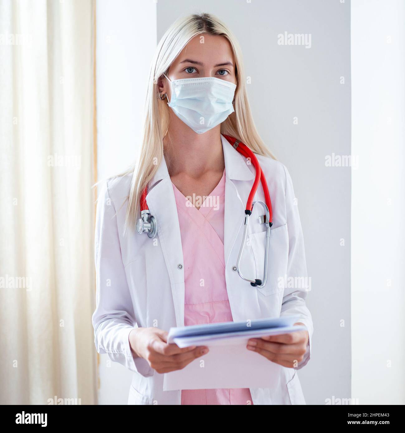 Portrait of young female doctor in mask Stock Photo