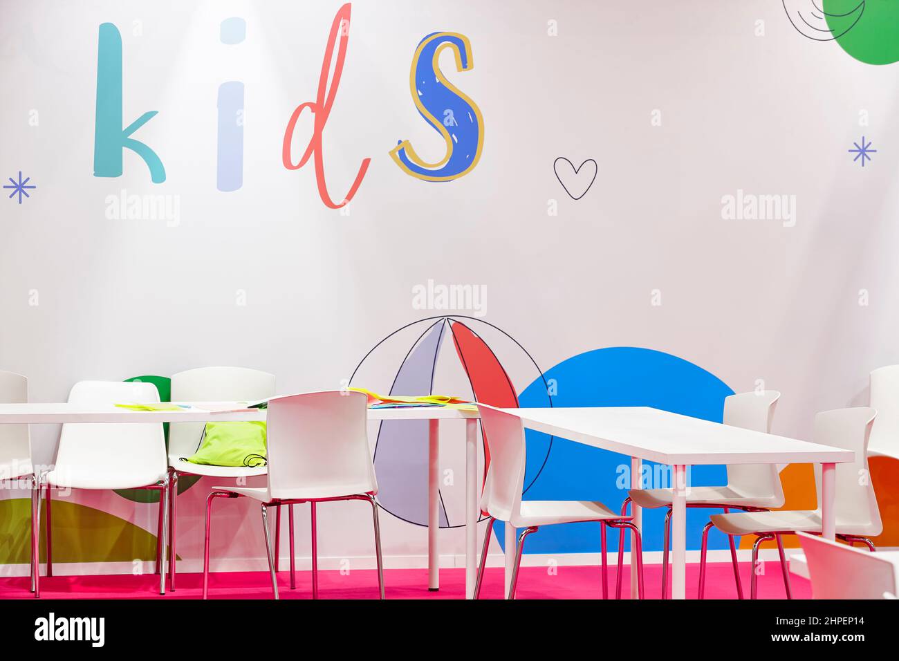Cute kindergarten interior with chairs and tables. Education classroom