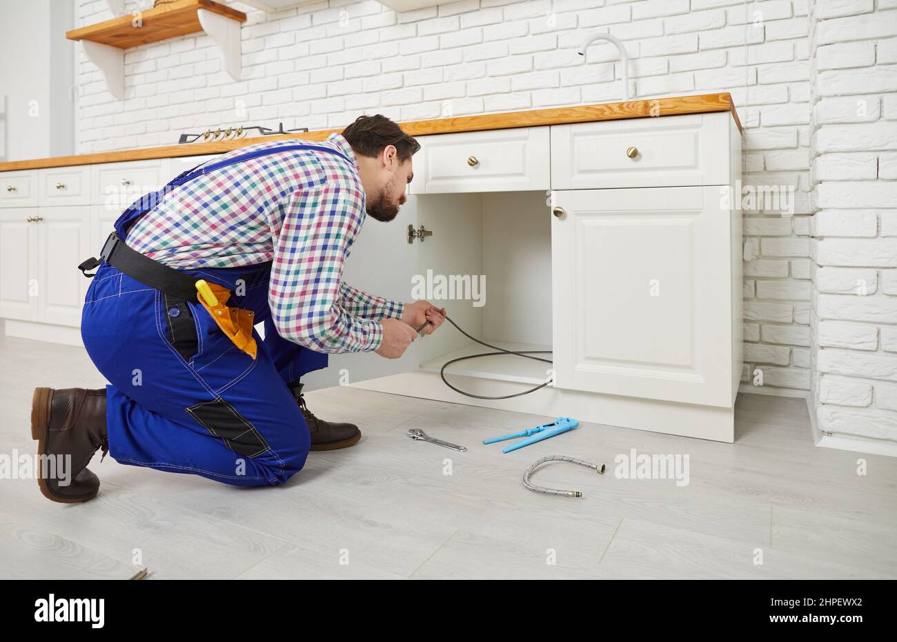 Male plumber repair pipe under sink in kitchen Stock Photo Alamy