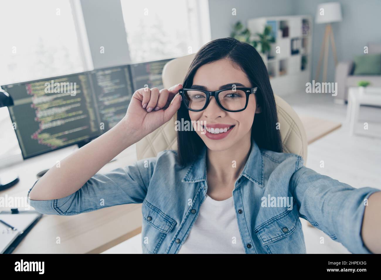 Portrait of smart chinese lady front end specialist make selfie video call seminar platform optimization in workstation. Stock Photo