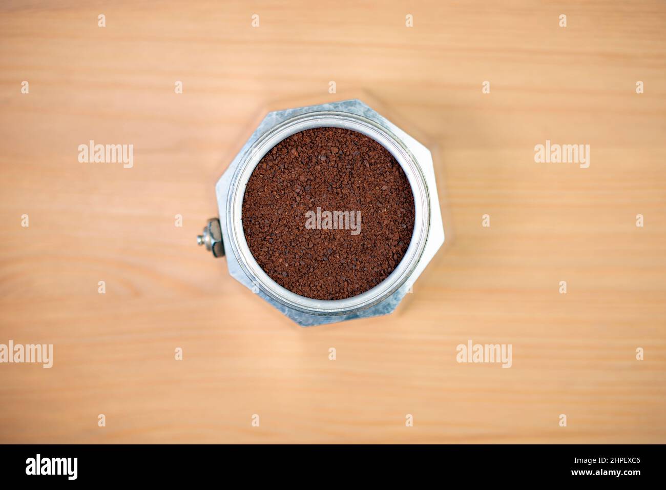 Stove top coffee machine moka percolator filled with ground coffee Stock Photo