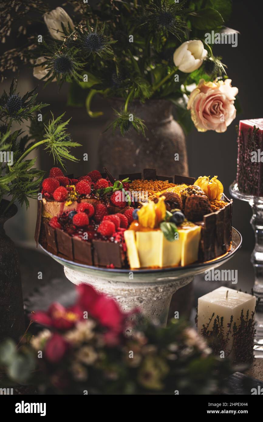 Different slices of various cakes, making a single whole torte on cake stand, still life Stock Photo