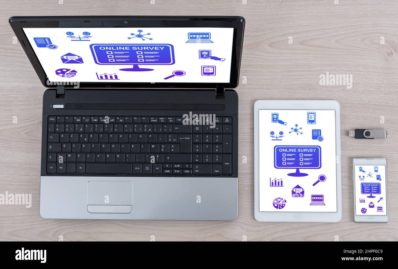 Online survey concept shown on different information technology devices Stock Photo