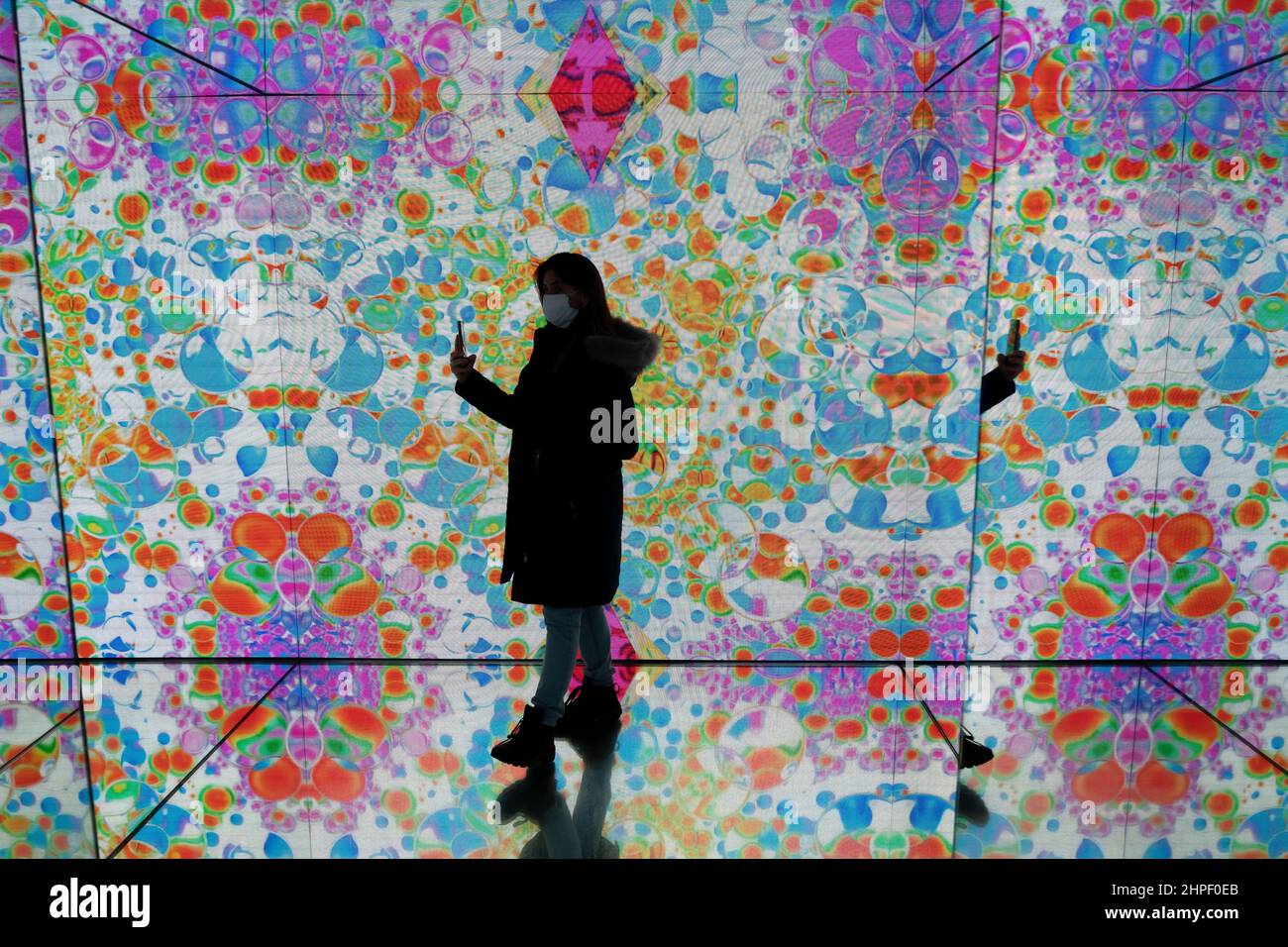 Visitor inside a room with the digital immersive art of Studio Irma in the Moco art museum of Amsterdam Stock Photo