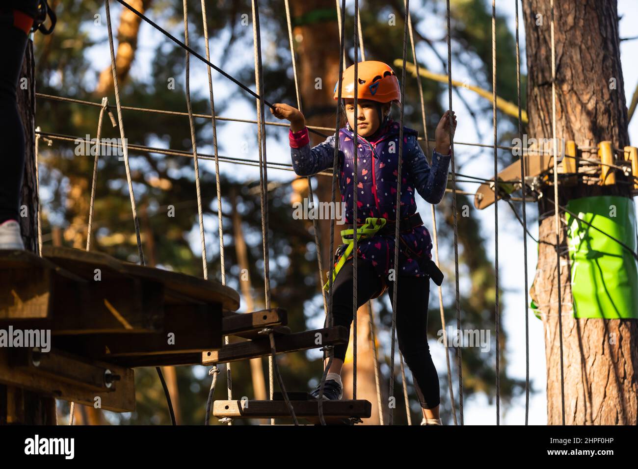 Girl climbing in adventure park is a place which can contain a wide
