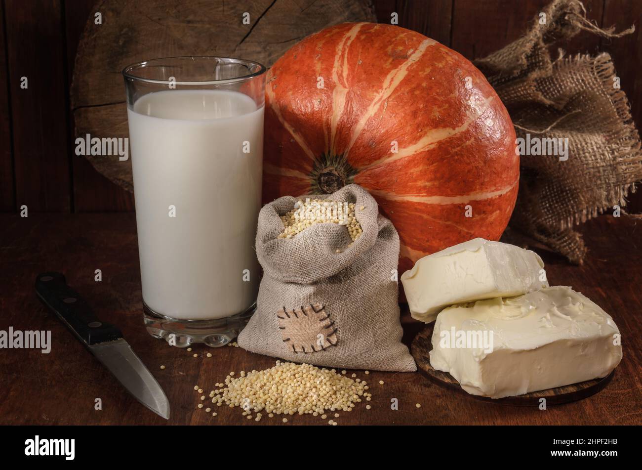 pumpkin, millet and other ingredients for pumpkin porridge on a dark background Stock Photo