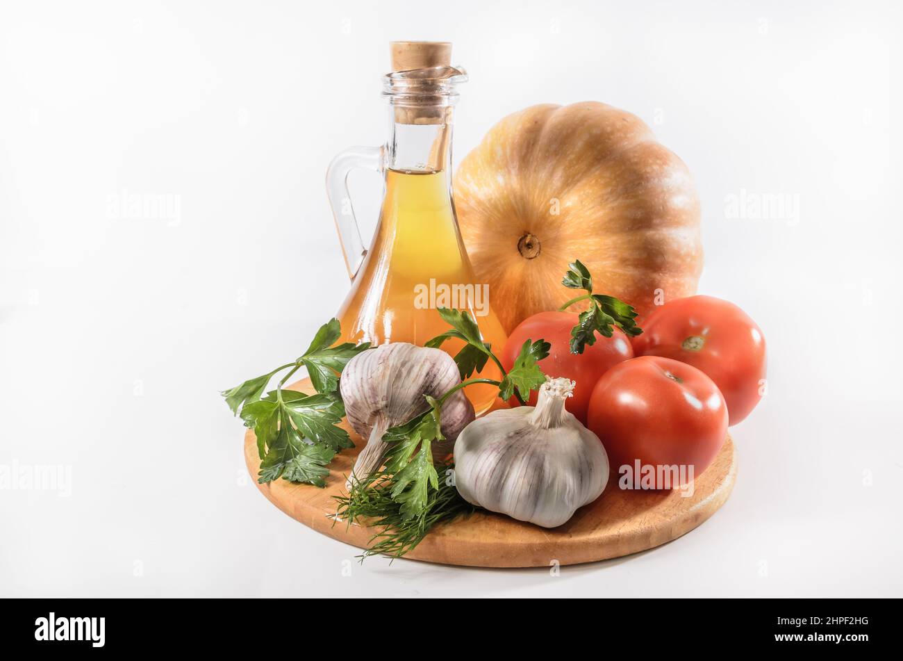 pumpkin, tomatoes and other ingredients for a vegetable dish on a light background Stock Photo