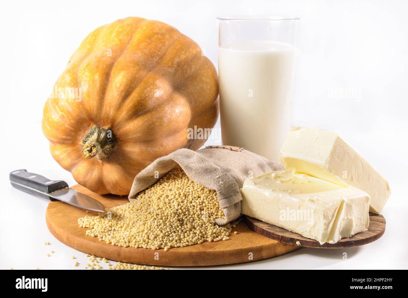 pumpkin, millet and other ingredients for pumpkin porridge on a light background Stock Photo