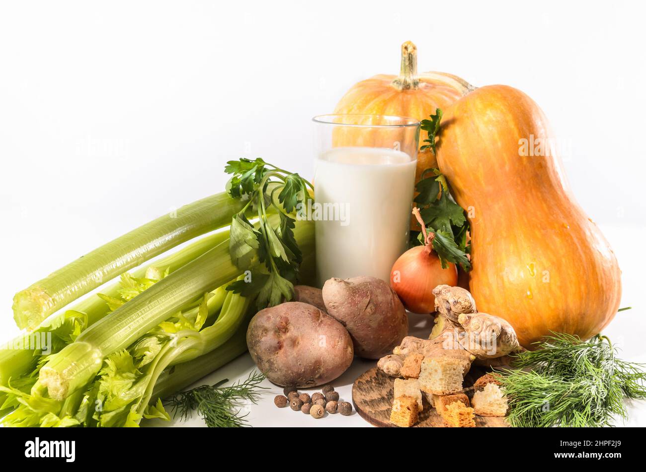 pumpkin, celery and other ingredients for pumpkin soup with breadcrumbs on a light background Stock Photo