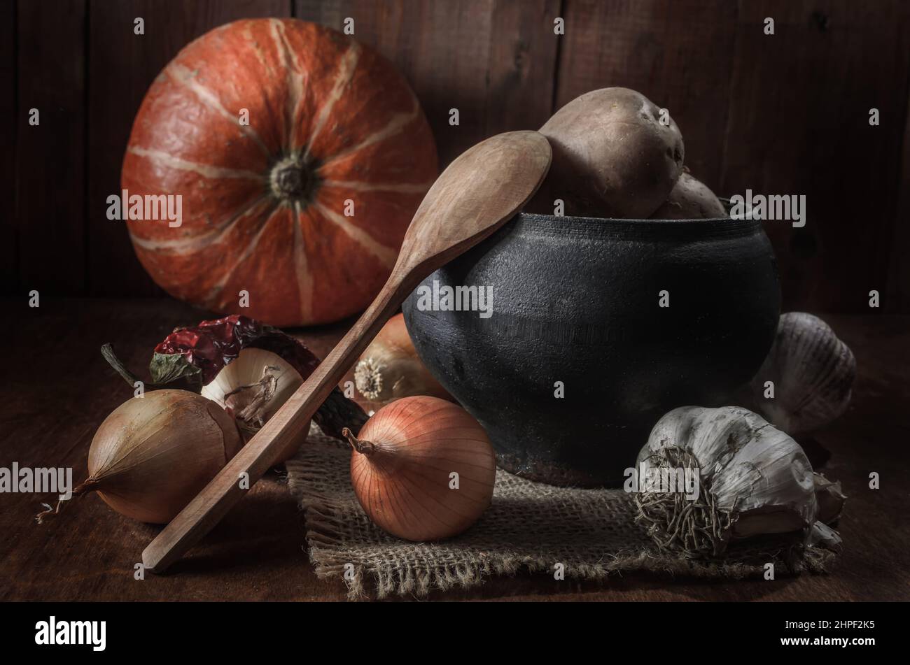 potatoes and other vegetables on a dark wooden background Stock Photo