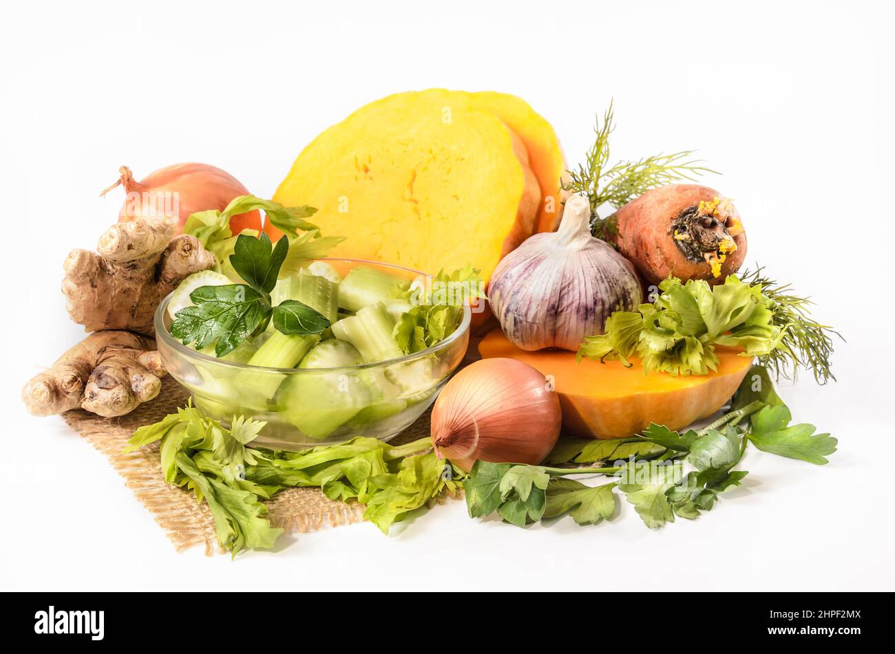 pumpkin and ingredients for pumpkin soup with celery and ginger on a light background Stock Photo