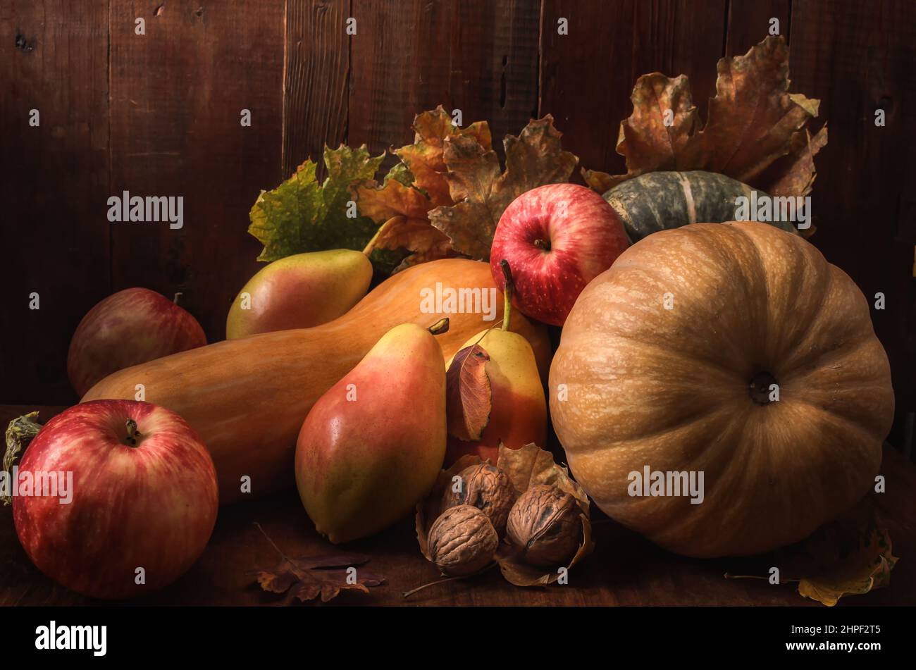 pumpkin and fruits in bulk on a dark wooden background in a rustic style Stock Photo
