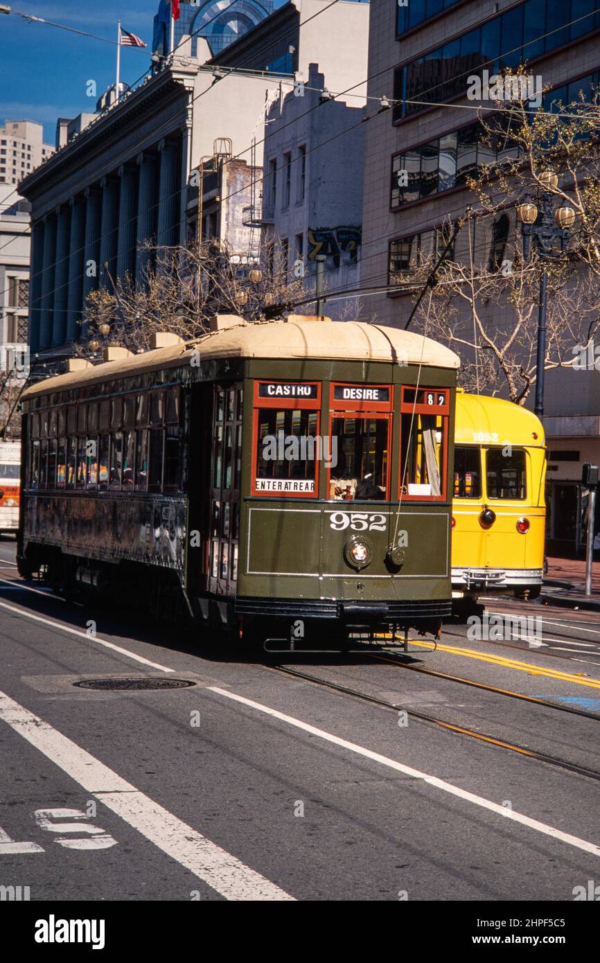 Two classic electric street cars pass in San Francisco, California