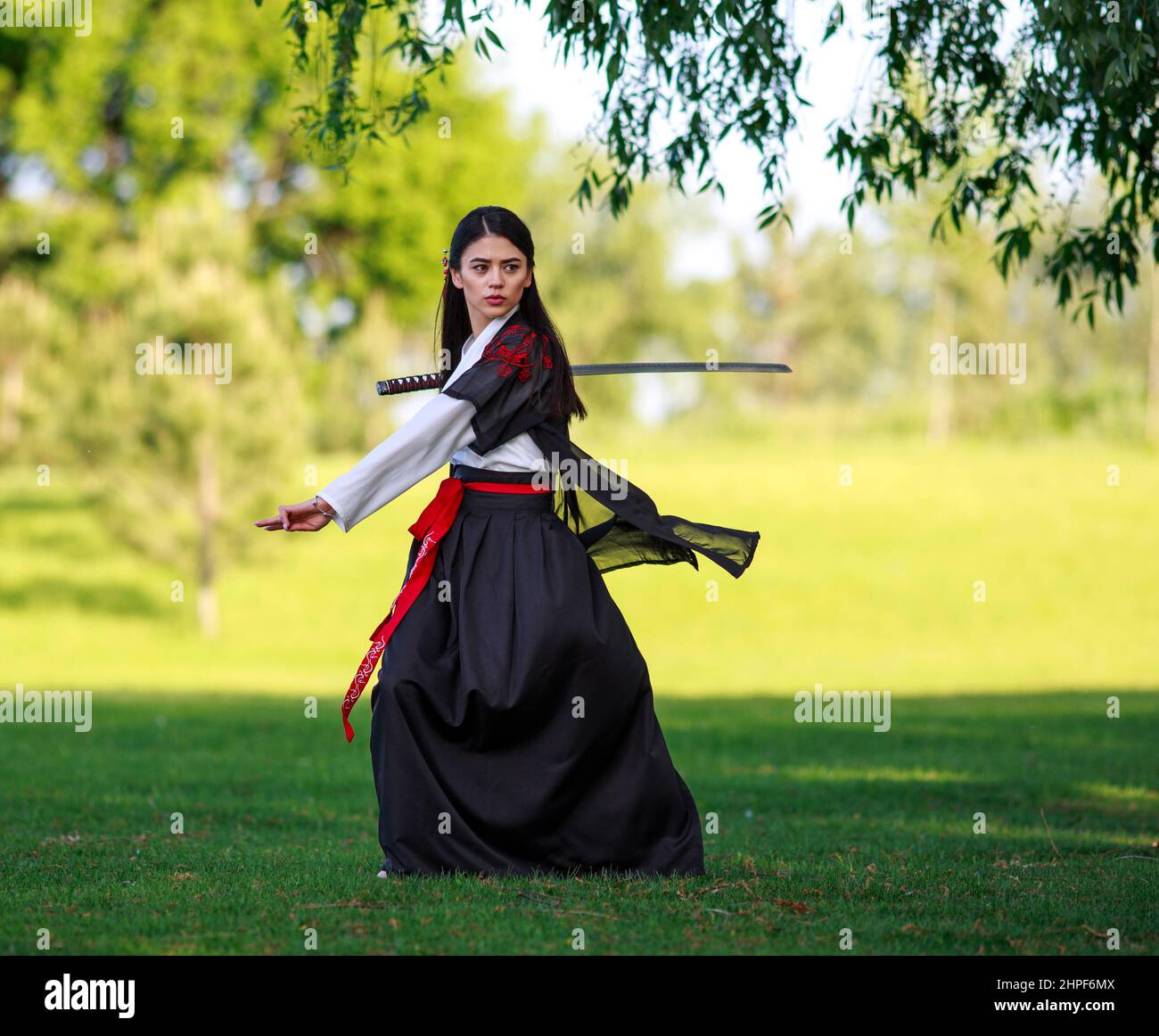 Young Asian Woman In Traditional Kimono Trains Fighting Techniques With Katana Sword Samurai 