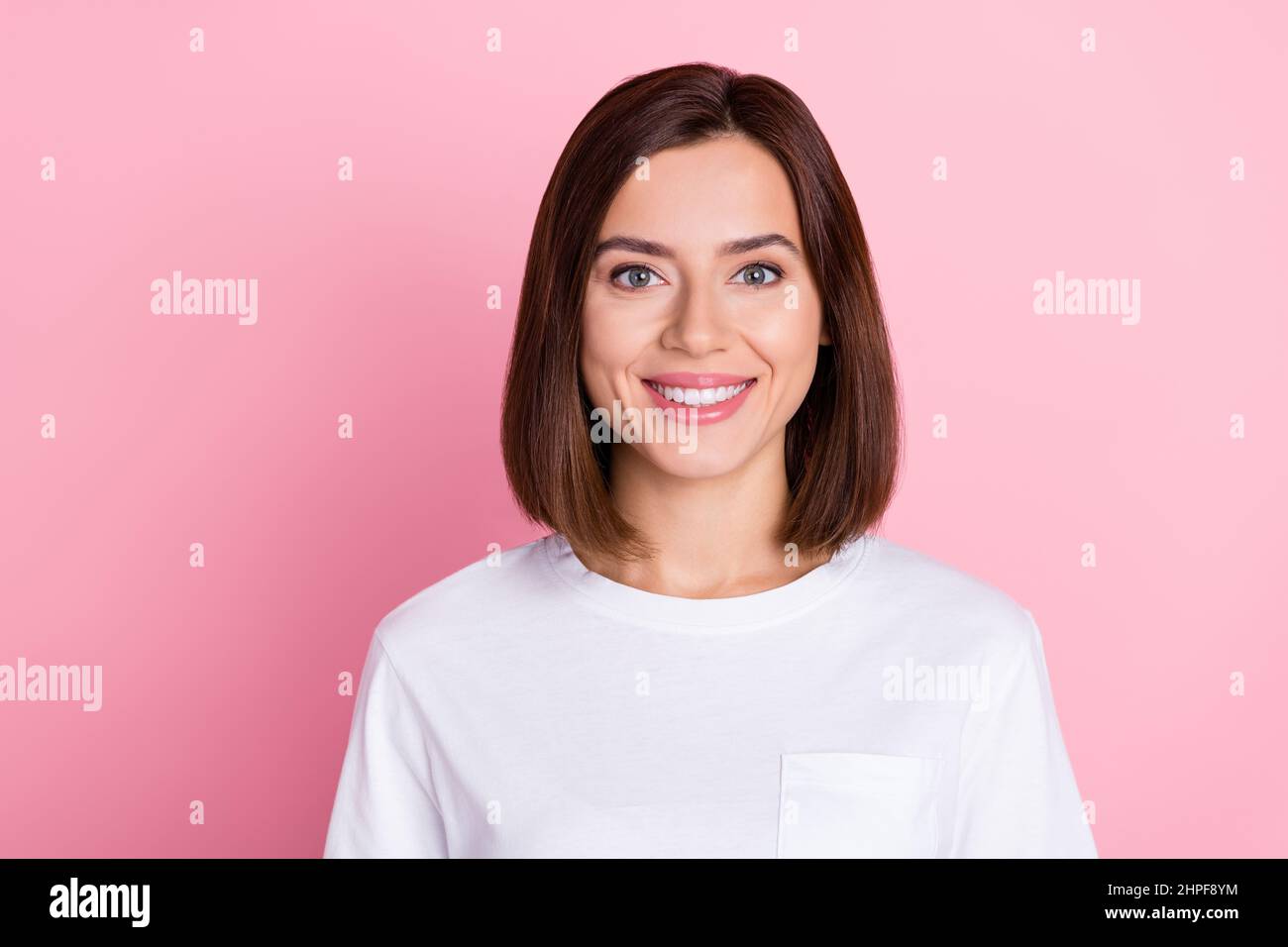 Photo of lovely young bob hairdo lady wear white t-shirt isolated on pastel pink color background Stock Photo