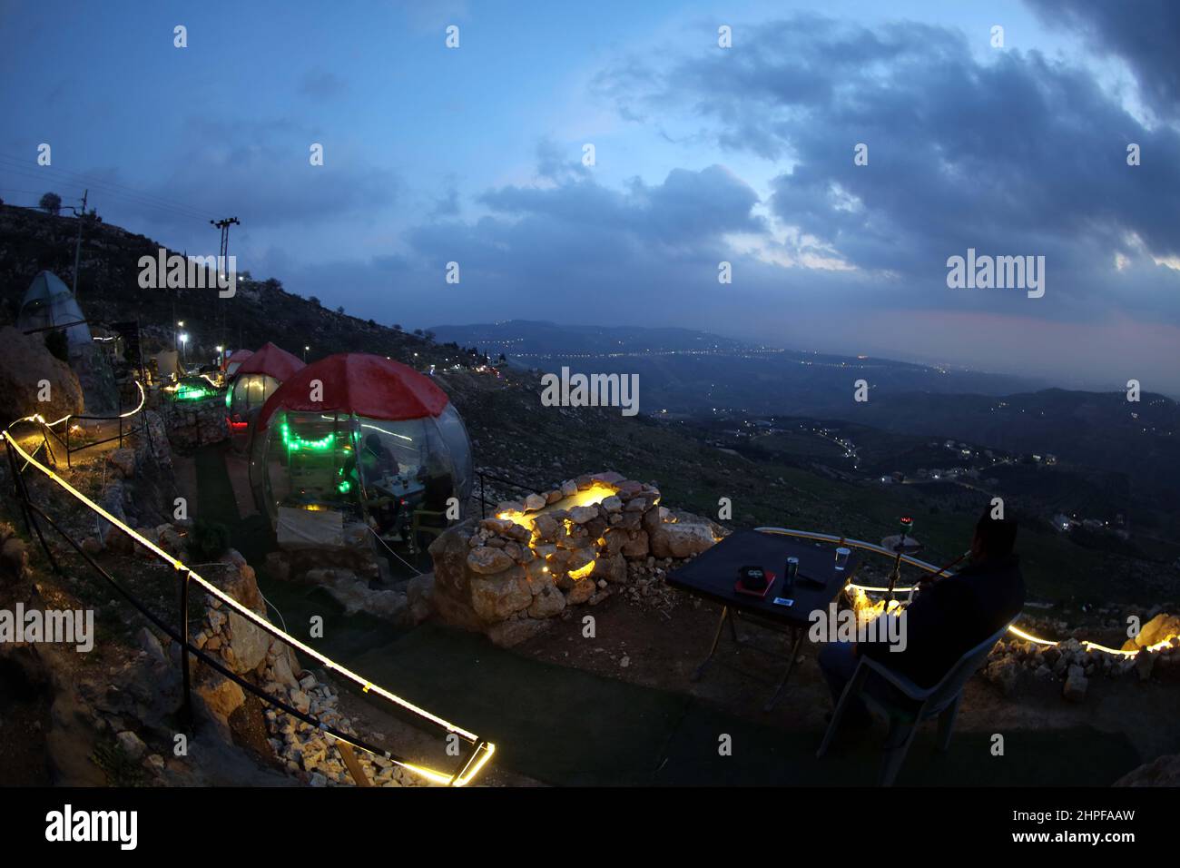 Amman, Jordan. 20th Feb, 2022. People smoke shisha in outdoor dining
