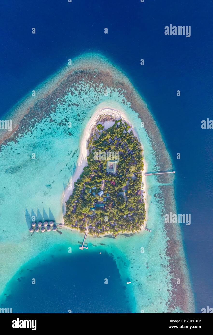 Tropical island with white sand beach, turquoise sea water and coral reef aerial top down view from drone. Perfect holidays vacation travel destinatio Stock Photo