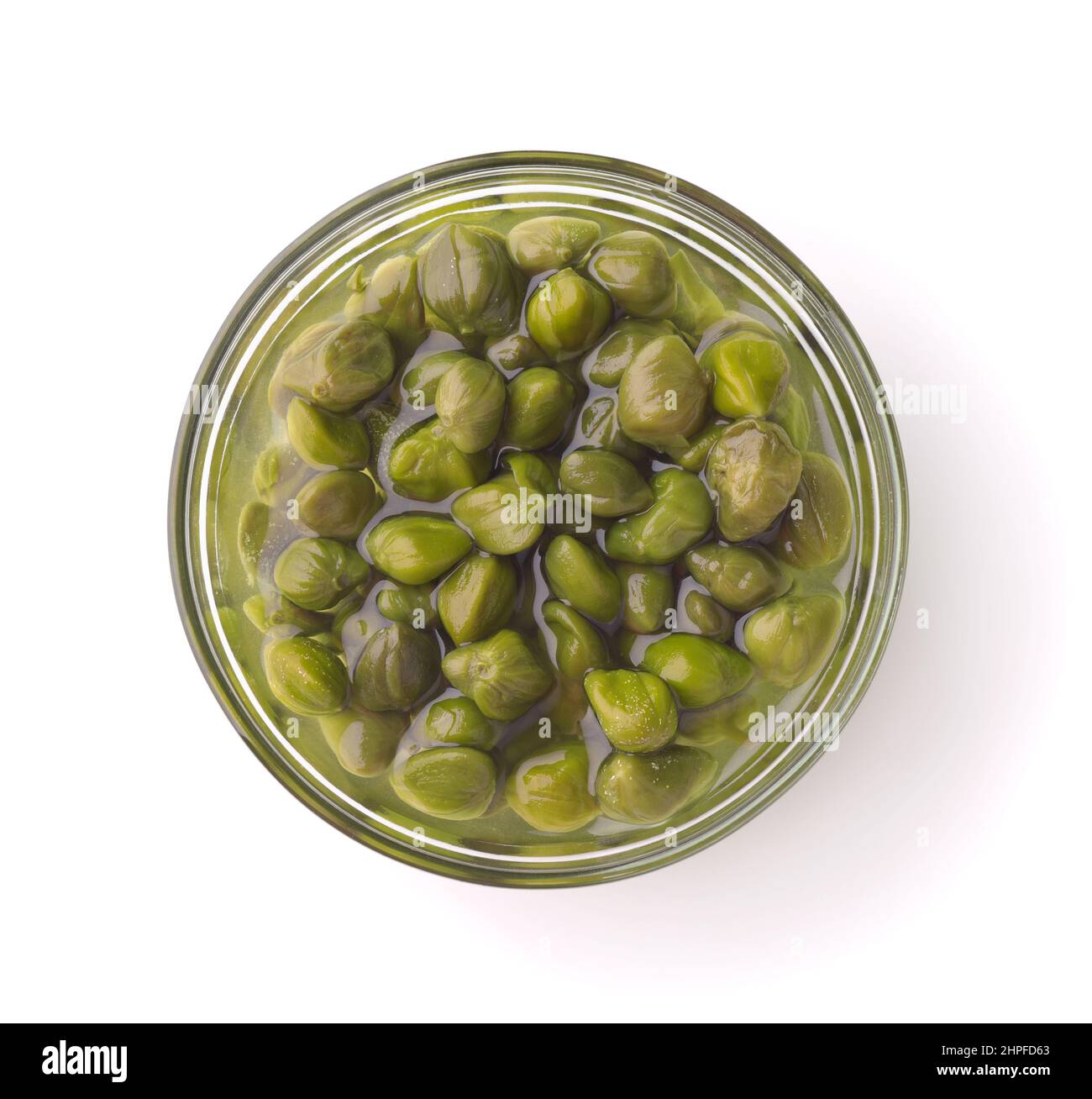 Top view of pickled capers in glass bowl isolated on white Stock Photo