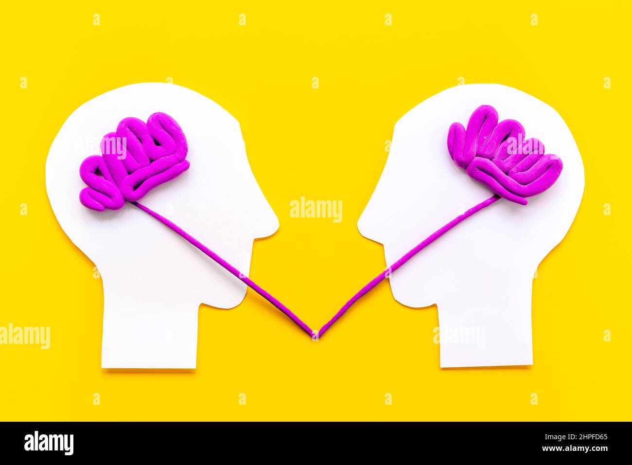 Human connection and communication. Brain on two paper human heads ...