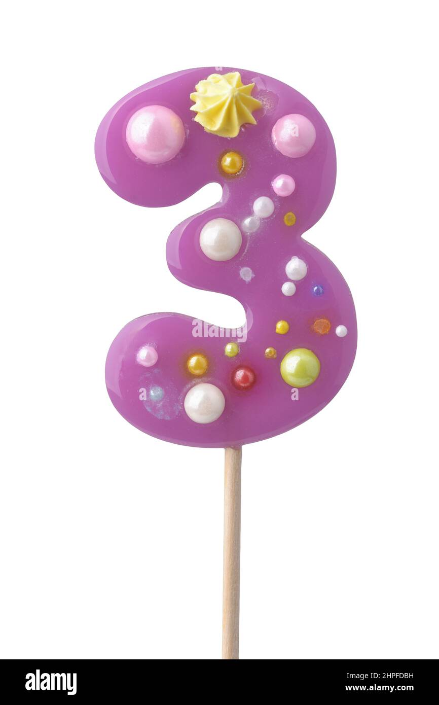 Front view of purple handmade number three lollipop isolated on white Stock Photo