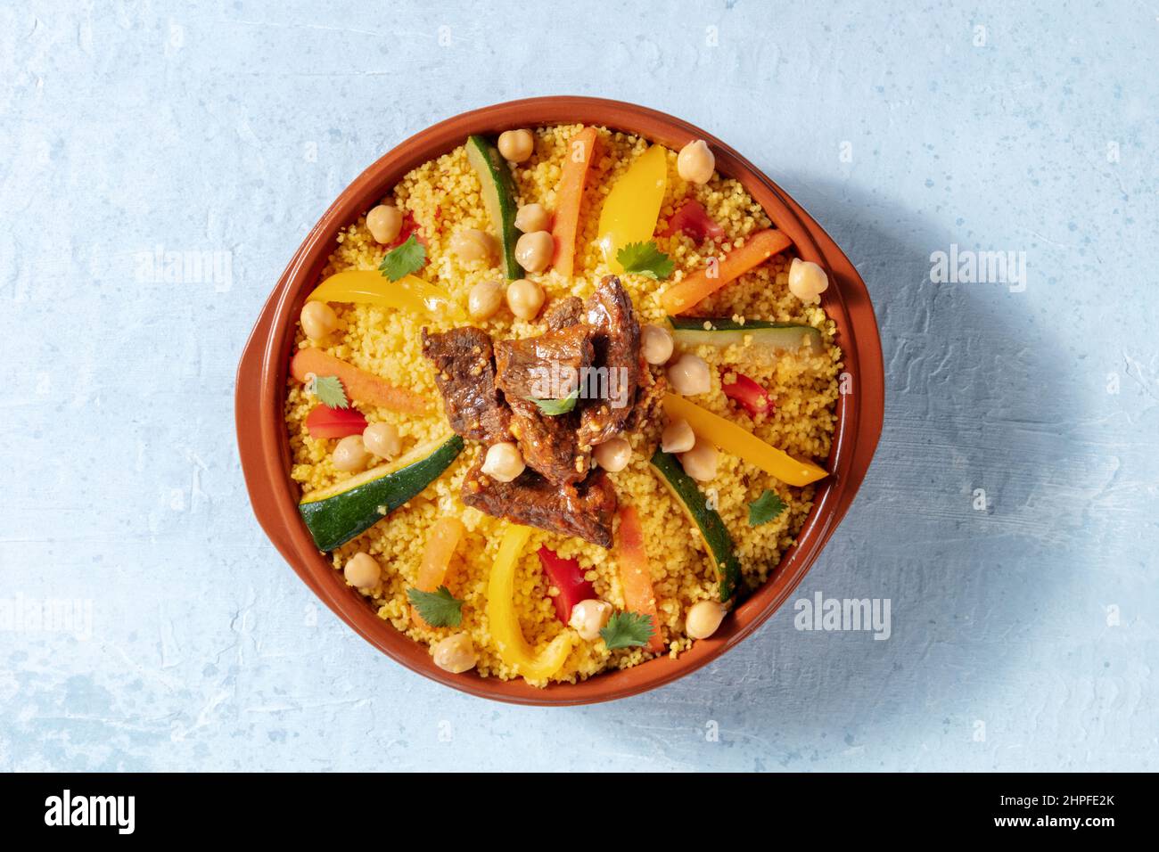 Meat and vegetable couscous, traditional Moroccan food, shot from the top, with chickpeas and cilantro Stock Photo
