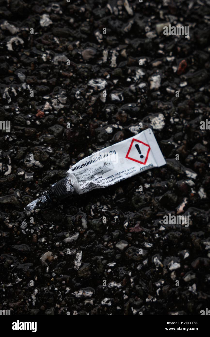 Hamburg, Germany. 21st Feb, 2022. An empty tube of superglue lies on the  roadway after climate activists of the action "Uprising of the Last  Generation" blocked an intersection at the customs office