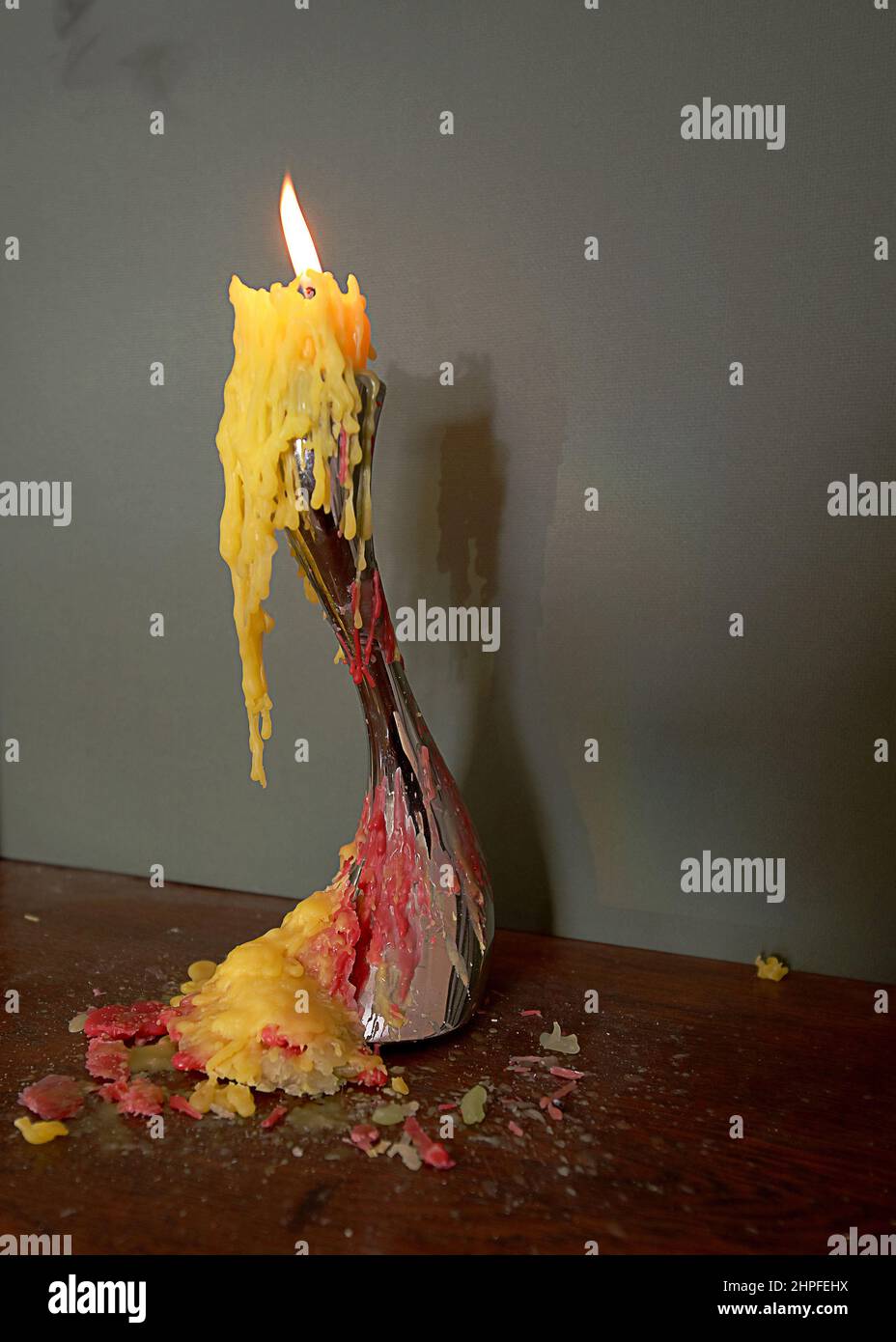 Different candle wax colours pouring from candle holder Stock Photo Alamy