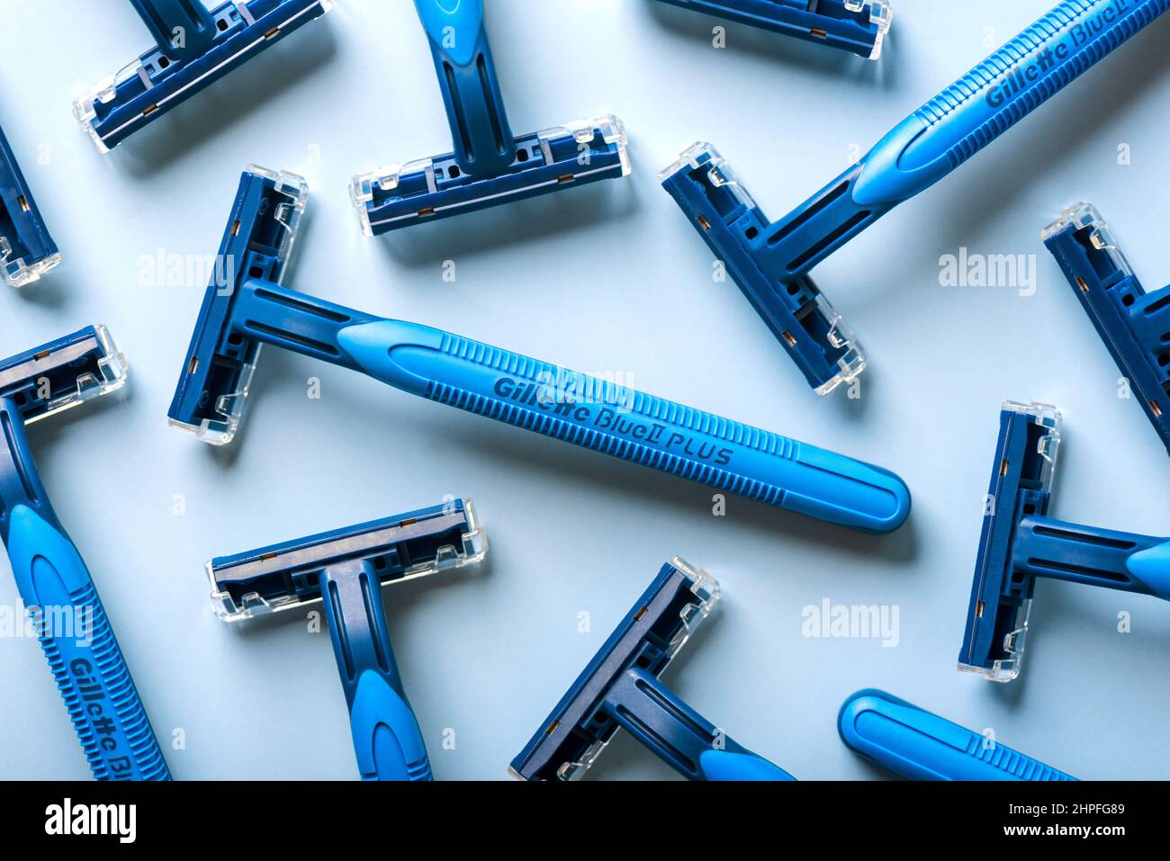 Closeup of Gillette Blue 2 razors Plus over blue background Stock Photo