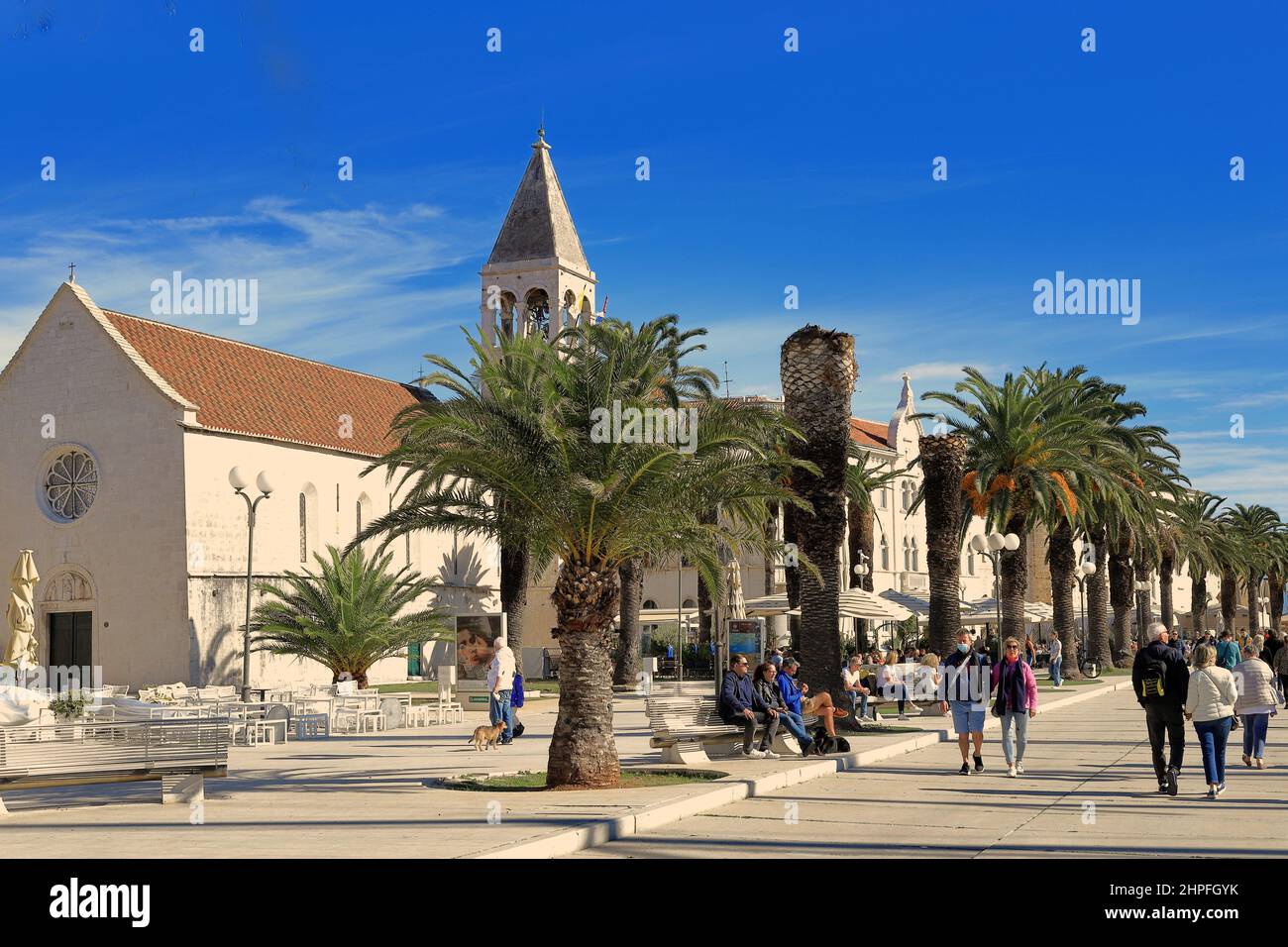 Trogir, Croatia - People walking along the Riva or Promenade in the old town on a sunny day Stock Photo