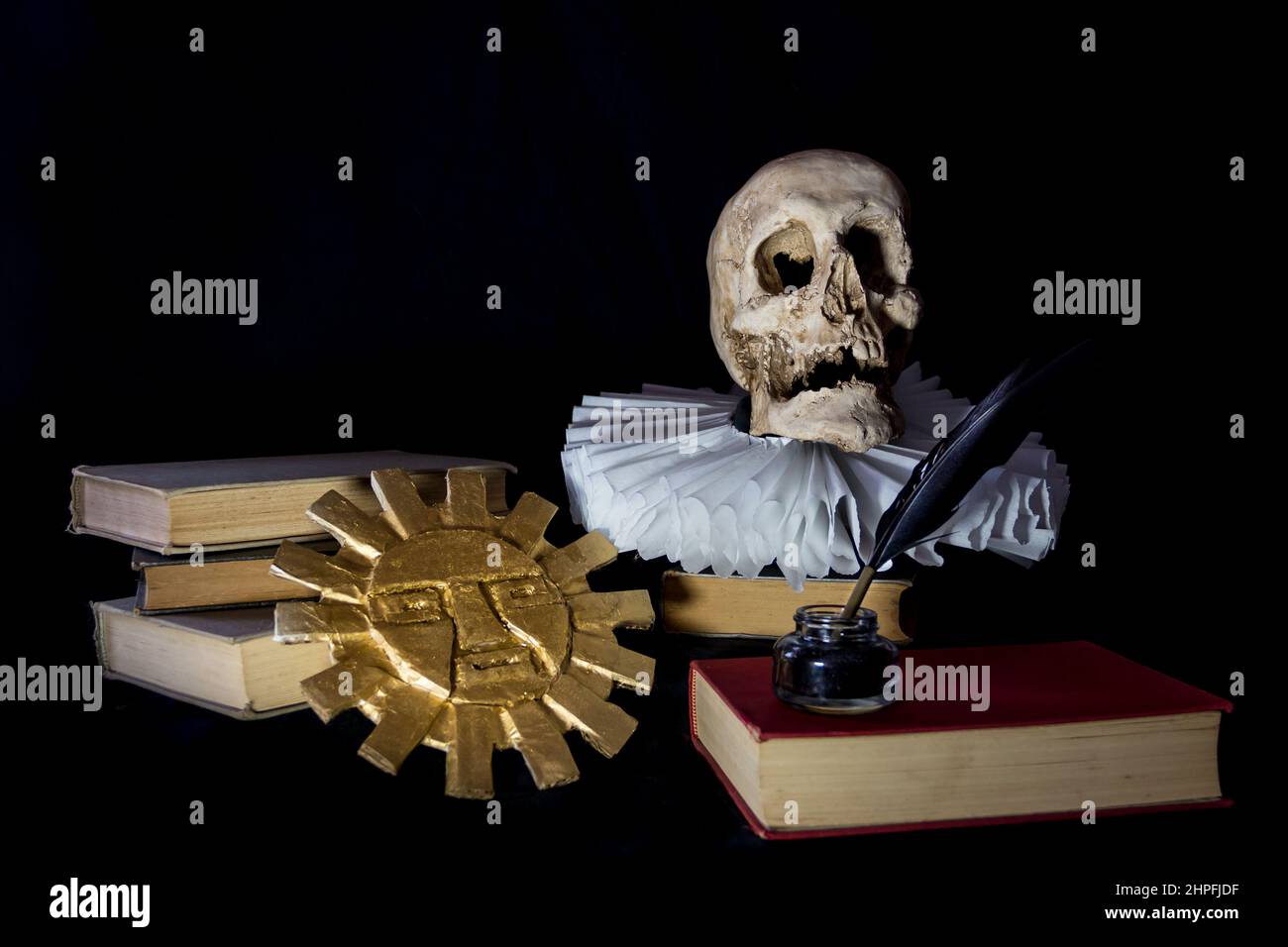 Books with a human skull, a ruff and the Inca sun, symbols of universal literature. Day of the book Stock Photo