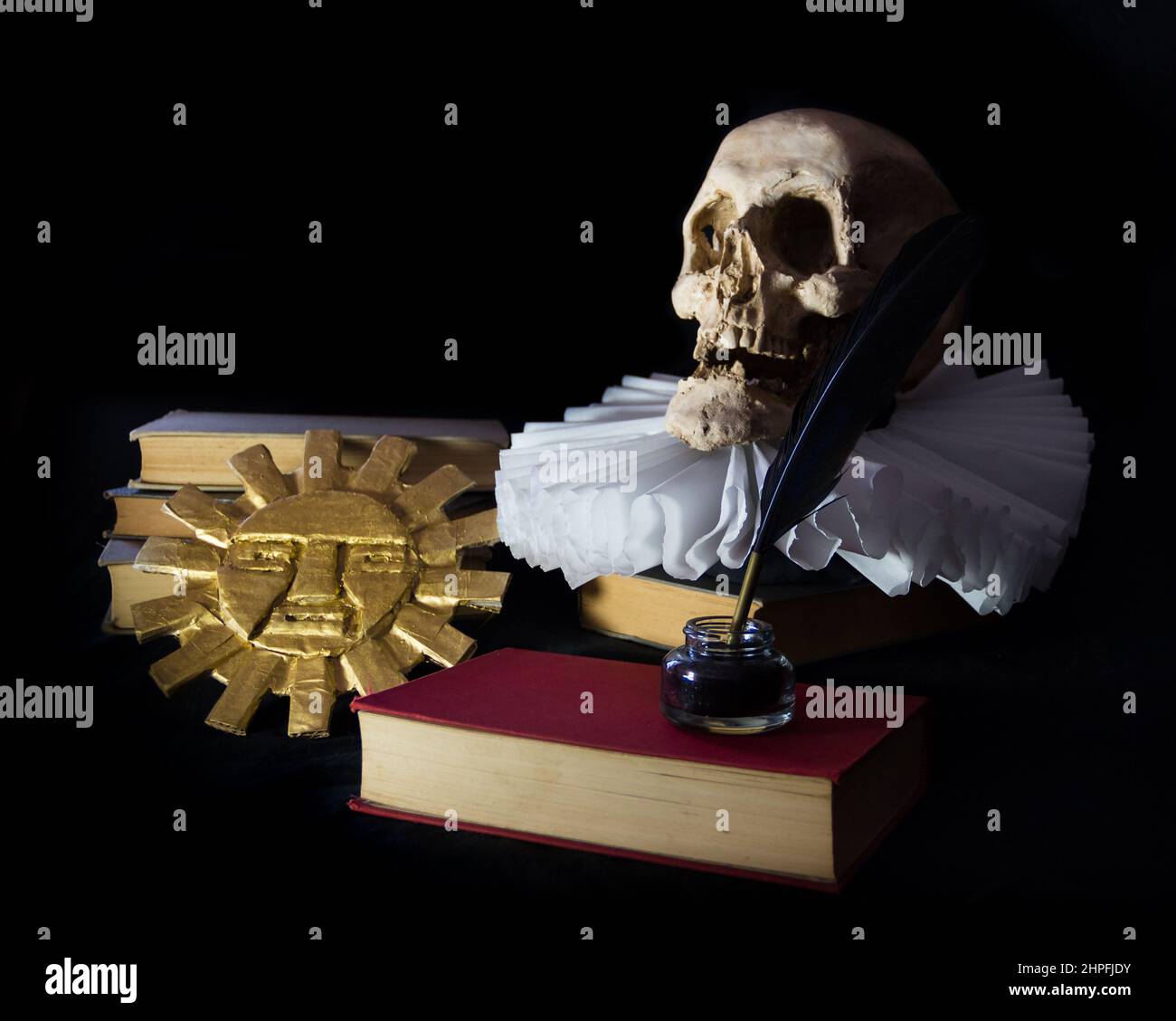Books with a human skull, a ruff and the Inca sun, symbols of universal literature. Day of the book Stock Photo