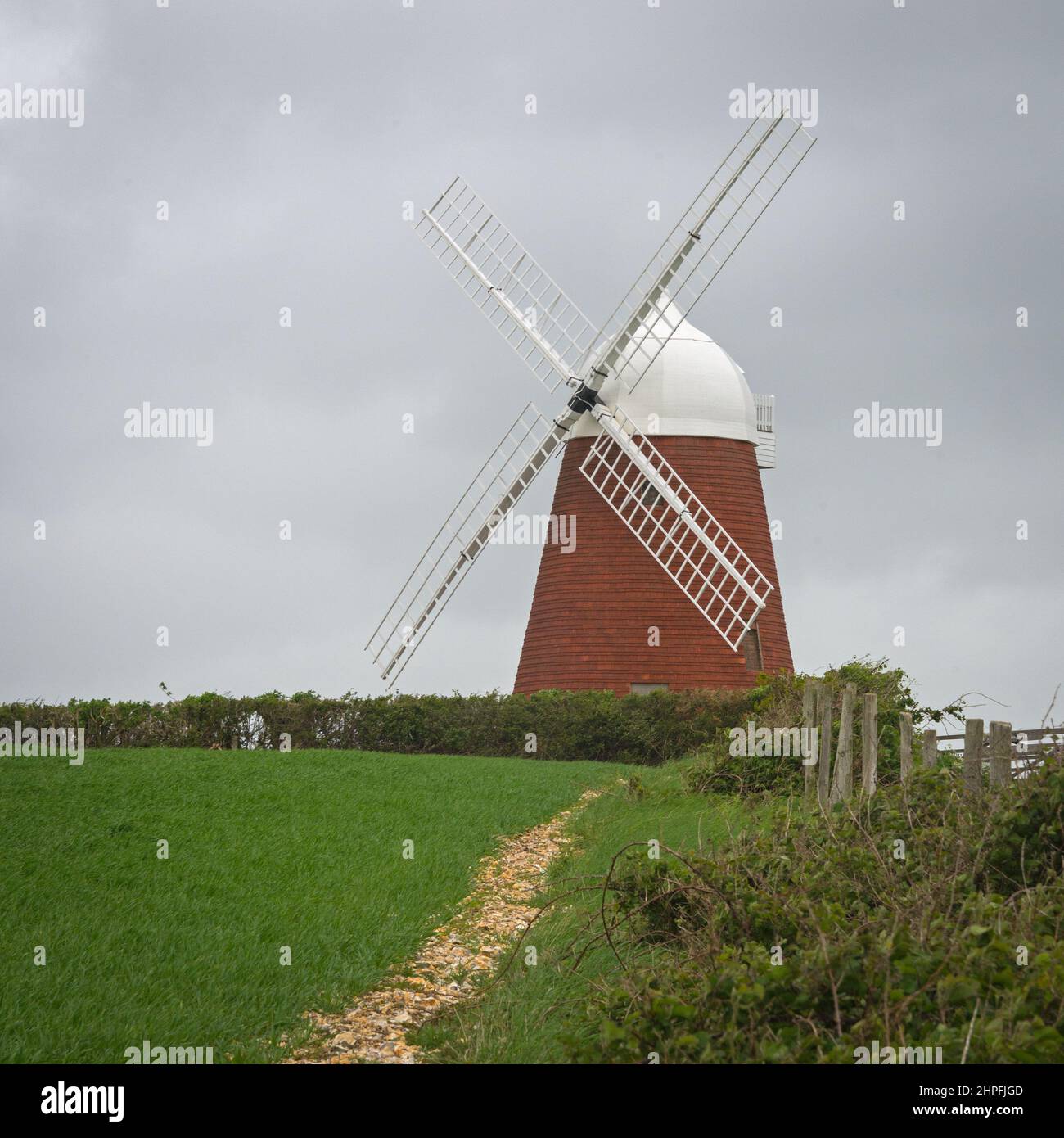 The restored 18c brick tower, Halnaker windmill, which has a 16 sided beehive cap, on top of