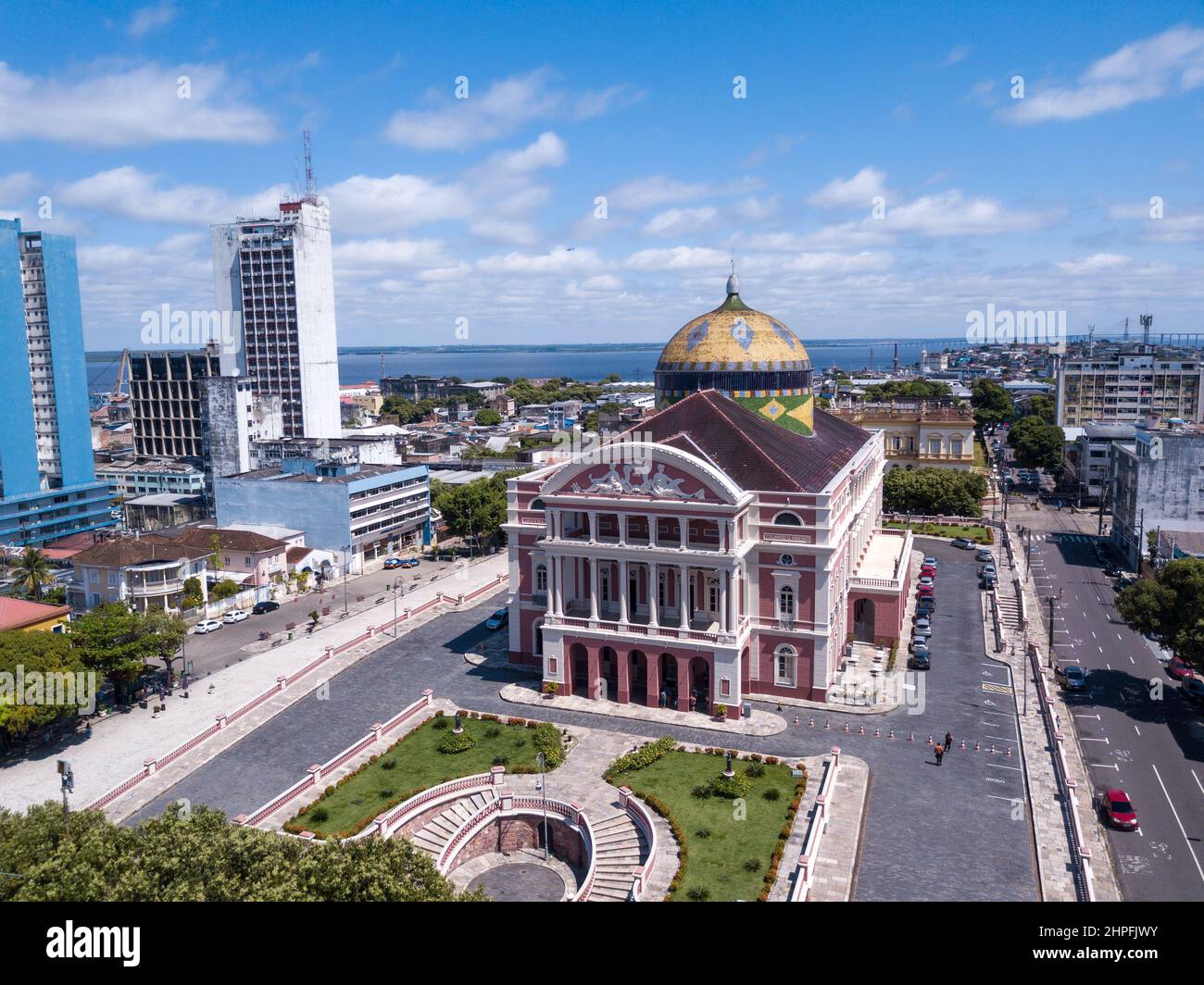 Beautiful drone aerial view of iconic Amazonas theater and city center houses, buildings and streets in sunny summer day in Amazon Rainforest. Brazil Stock Photo