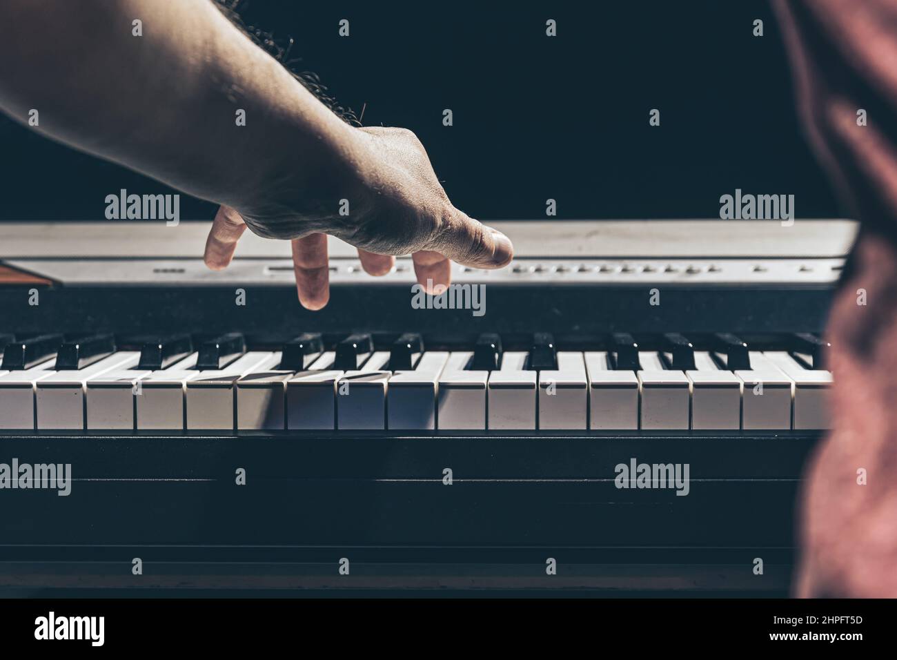 Male hands play the piano keys in the dark Stock Photo Alamy