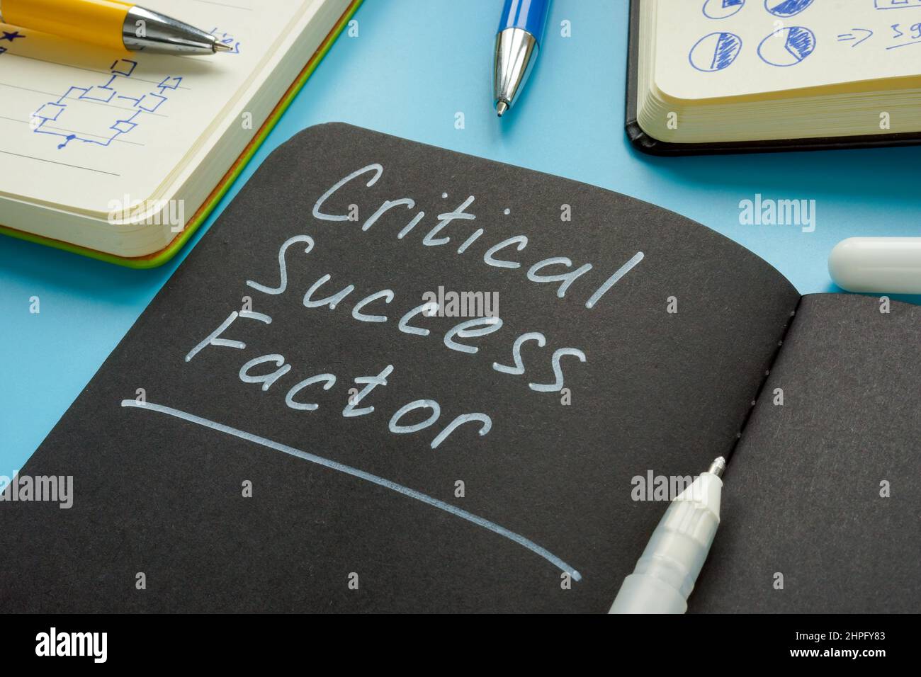 Critical success factor memo in the notepad and pen. Stock Photo