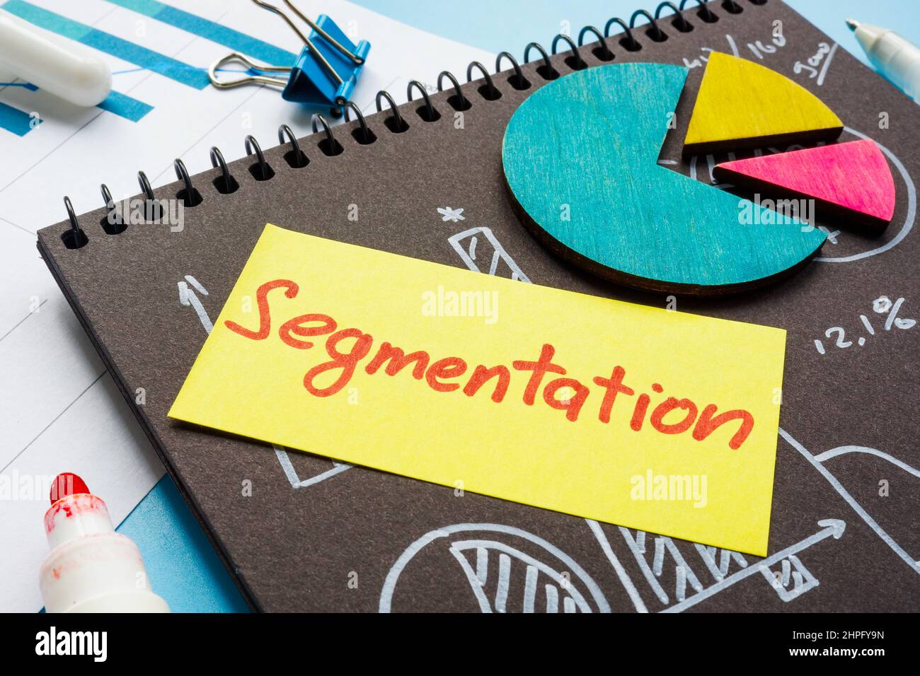 Papers with charts and graphs and Segmentation memo on it. Stock Photo