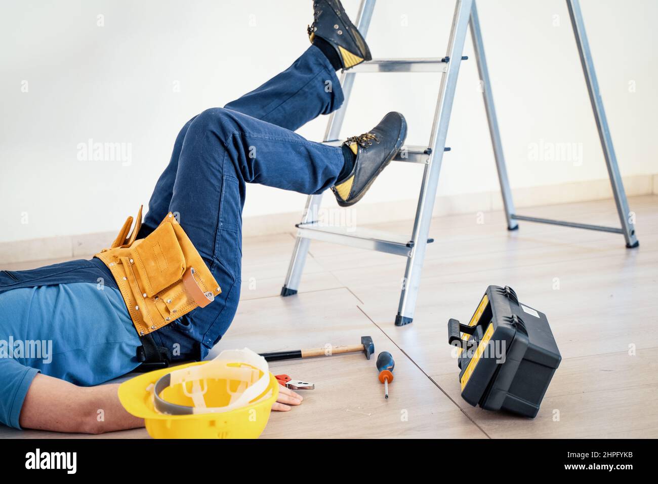 Safety rules in construction site concept, worker injured at work Stock Photo