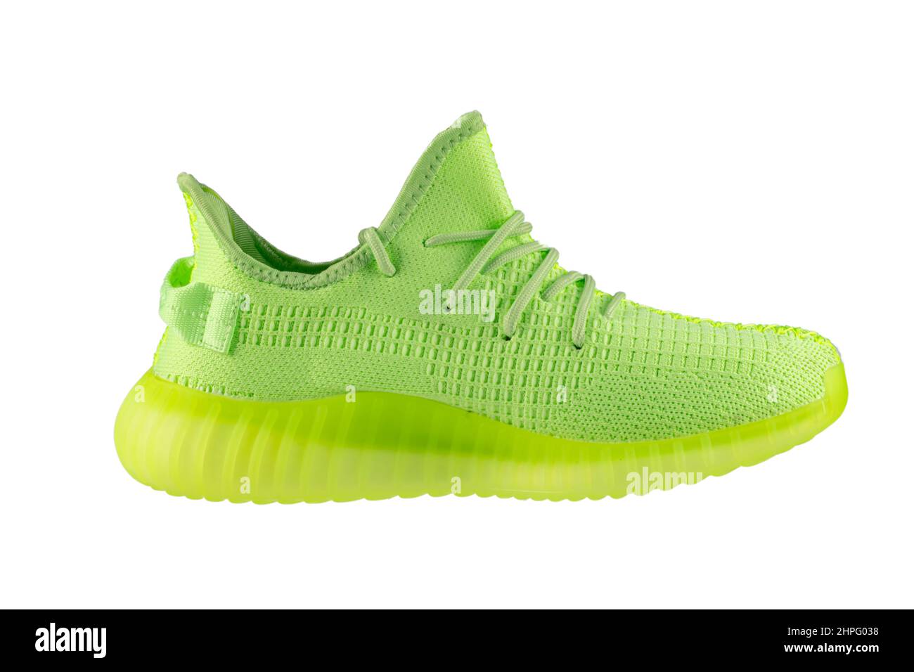 Green rag sneaker with a polyurethane sole on a white background. Stock Photo
