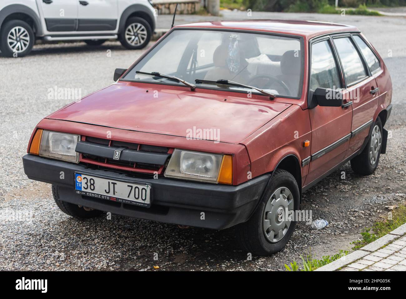 Side, Turkey -January 27, 2022: red 2109 vaz  is parking  on the street on a  summer day against the backdrop of a  road Stock Photo