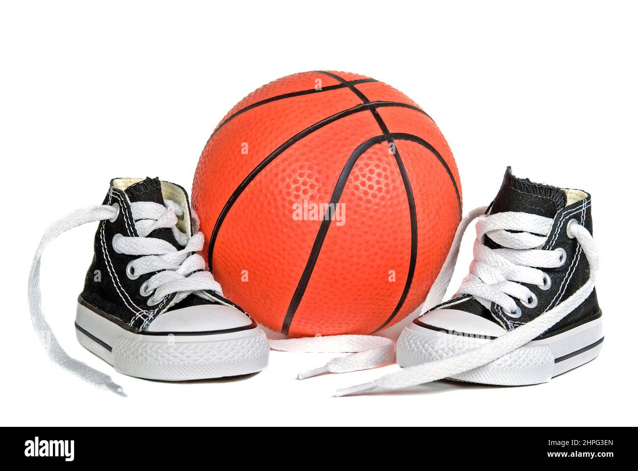 Child's black and white sneakers with basketball isolated on white background Stock Photo