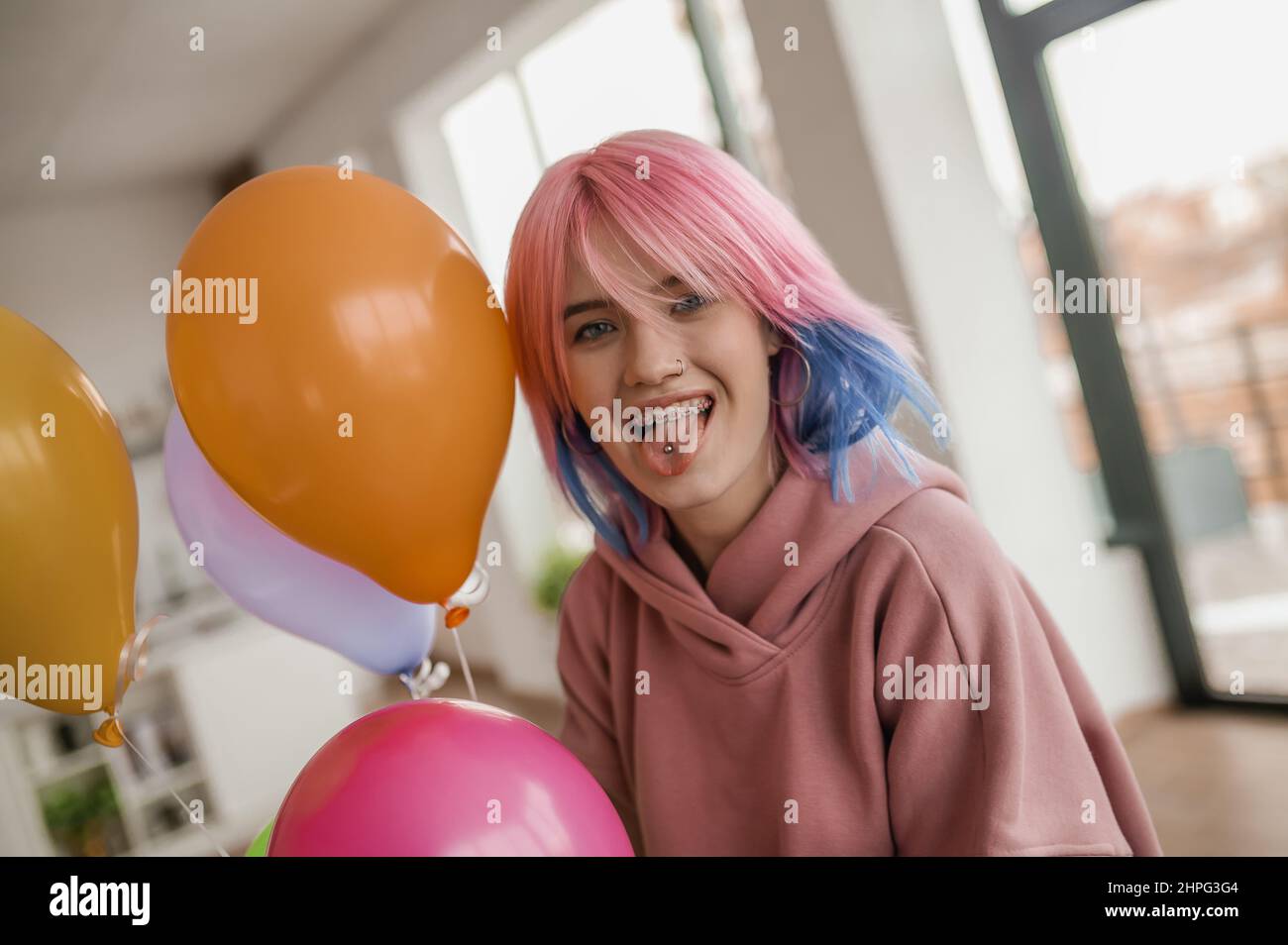 Cute young girl with colored hair looking happy Stock Photo