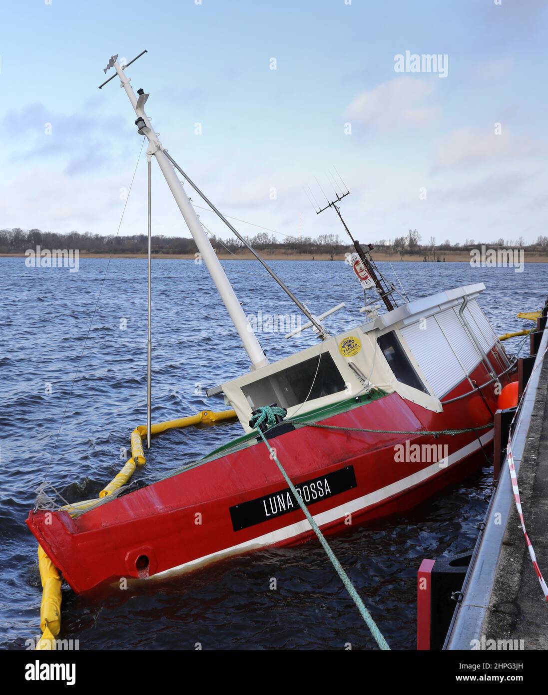 Rostock, Germany. 21st Feb, 2022. The fishing vessel 'Luna Rossa' sank to the bottom of the city harbor during the storm 'Antonia'. 'Antonia' ended the series of severe storms over large parts of Germany. Credit: Bernd Wüstneck/dpa-Zentralbild/dpa/Alamy Live News Stock Photo