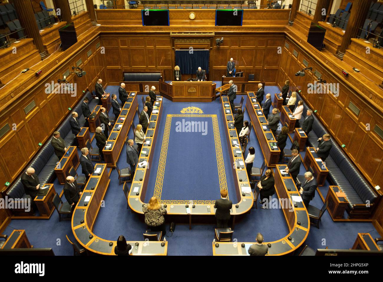 Members of the Northern Ireland Assembly stand in the Assembly chamber at Stormont during a minutes silence to DUP politician Christopher Stalford. Warm tributes have been paid from across the political benches at Stormont following the sudden death of the 39-year-old father-of-four at the weekend. Picture date: Monday February 21, 2022. Stock Photo