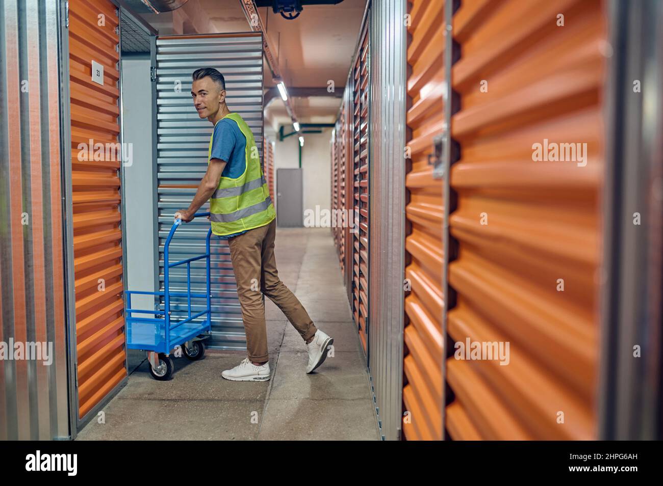 Pleased warehouse operative entering the cargo container Stock Photo