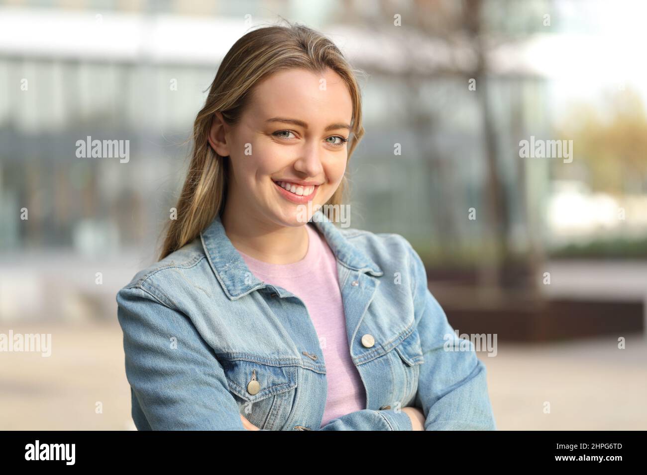 Happy casual teen posing looking at camera standing in the street Stock Photo
