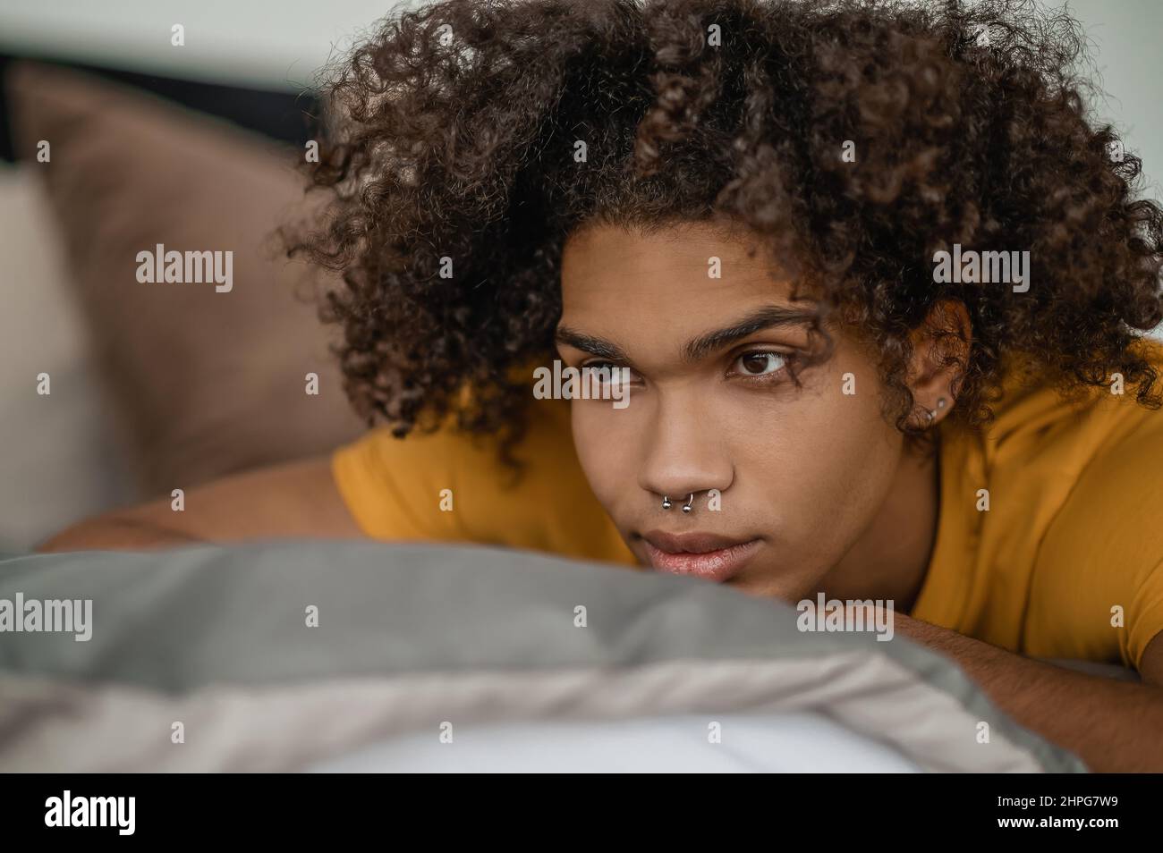 Waist up of a young mulatto with curly hair Stock Photo